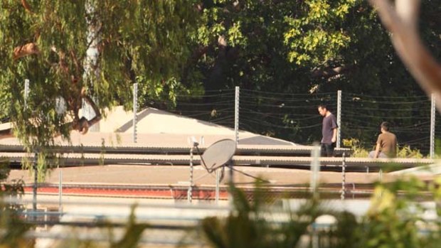 Detainees on a rooftop  at  Darwin's immigration detention centre yesterday.