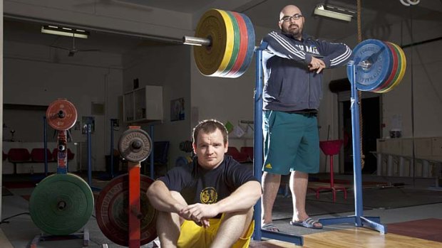 Amazed at teammate's action ... weightlifters Ben Turner and Damon Kelly at training in Brisbane yesterday.