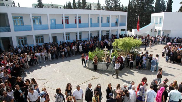 Tunisians voters queue at a polling station in Menzeh, near Tunis.