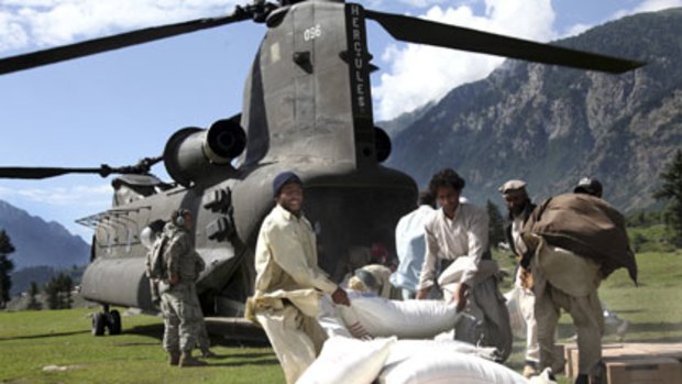 Food aid ... Pakistanis with flour from a US helicopter.