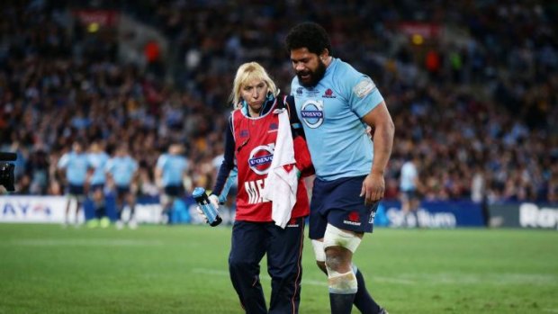 Hooked: Waratahs rake Tatafu Polota-Nau is assisted from the field during the Waratahs' win in Saturday's Super Rugby final.