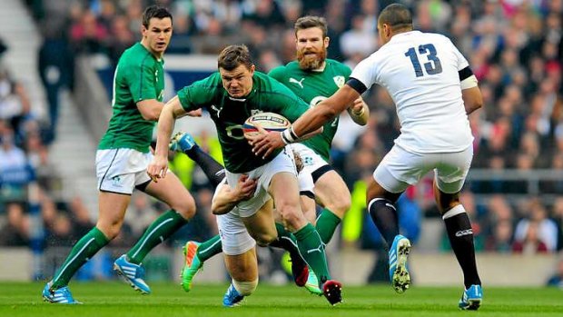 Spirit willing: Ireland centre Brian O' Driscoll on the burst against England as he equalled the world record for Test caps held by George Gregan.