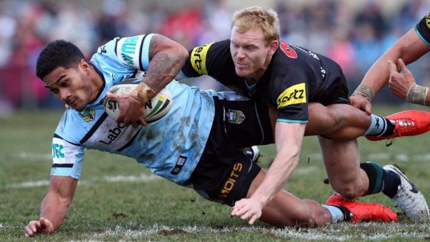 Out of action: Penrith’s  Peter Wallace tackles Cronulla’s Ricky Leutele on Saturday. An ACL injury has ended Wallace’s season.