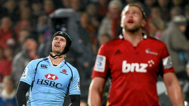 And it's ... wide: Berrick Barnes watches in anguish as his penalty attempt sails wide of the posts after the siren in Christchurch as the Waratahs lose by a kick for the second week in a row.