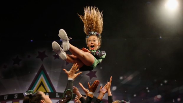 What a throw ... performing at the cheerleading competition.