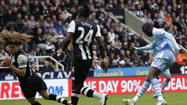 Manchester City's Yaya Toure (R) scores his first goal against Newcastle United.