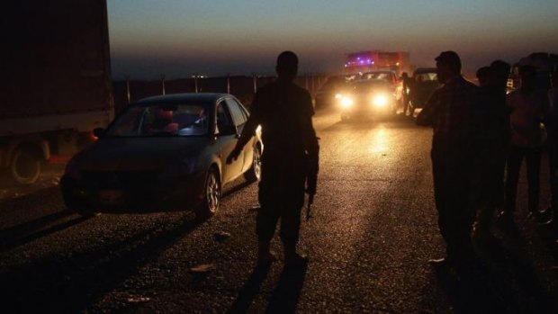 Vehicles are checked by Kurdish Peshmerger forces at a checkpoint on the Mosul Road.