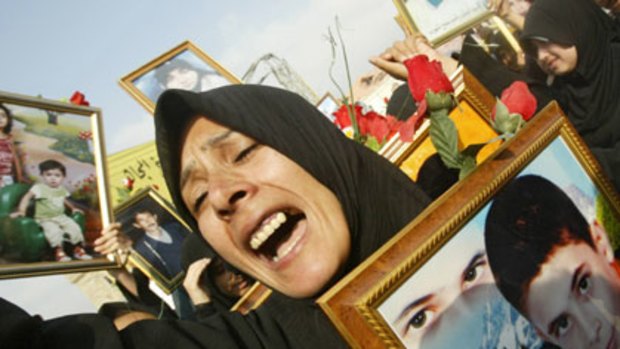 A Lebanese woman holds a picture of her two children killed in Israeli raids in 2006.