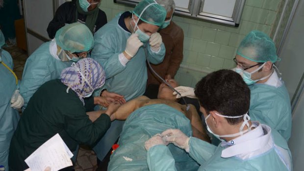 A Syrian injured during an alleged chemical attack at Khan al-Assal is treated by doctors at a hospital in Aleppo.