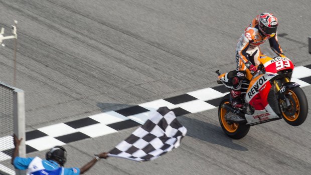 Marc Marquez does a wheelie after crossing the finish line in the Malaysian MotoGP.