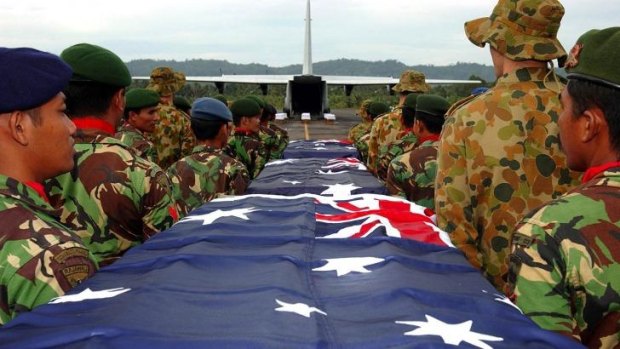Setting the standard: Indonesian officers provide a full military detail to honour Australian air force and naval personnel who died while delivering aid in the wake of the 2004 tsunami.