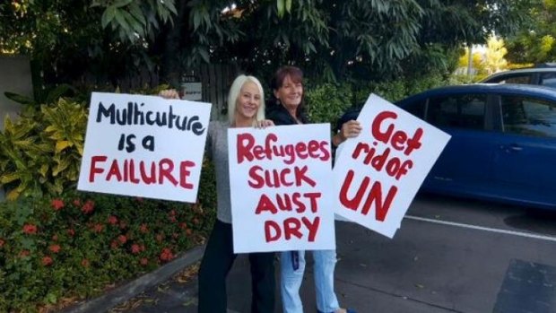 Strong views ... Vuga, left, and a friend with placards for their 'counter-protest'.