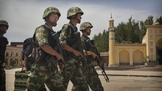 Chinese soldiers patrol outside the Id Kah mosque in Kashgar, in the far western region of Xinjiang.