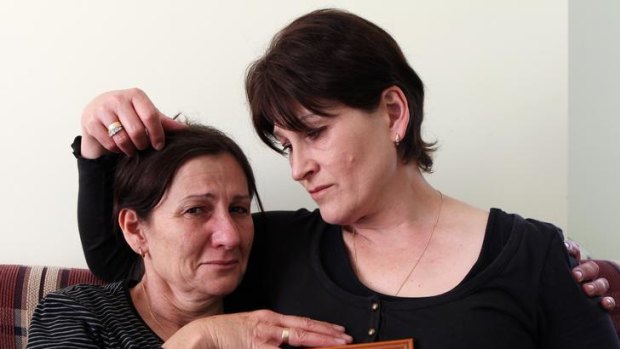 Nada Dacich, left, and Jelena Jurkovic with a portrait of their mother, Anka Dukich, who had a wrongly labelled wristband placed on her when she was admitted to Westmead Hospital.