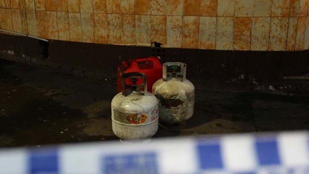 Gas cylinders and a fuel tank sit behind police tape at the  Abercrombie Hotel.