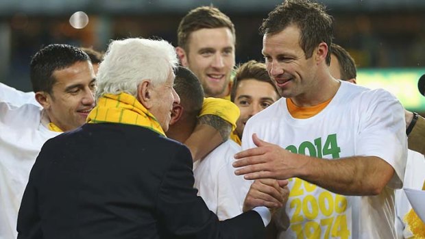 Chariman Frank Lowy celebrates with Socceroos captain Lucas Neill.