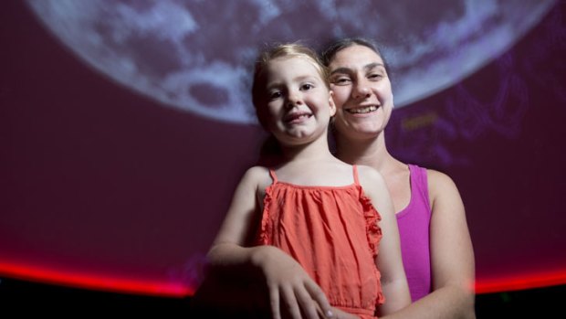 Brigette Kerridge-Flaim, 5, with her mum Anna Flaim in the Cosmic Skydome at The Sir Thomas Brisbane Planetarium on March 30, 2013.