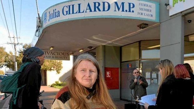 Single mother of three Angela Downey protests outside Prime Minister Julia Gillard's electoral office.