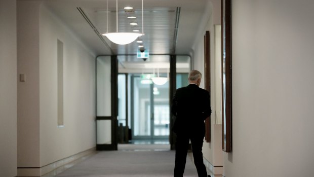 Prime Minister Malcolm Turnbull returns to his office after the announcement. 