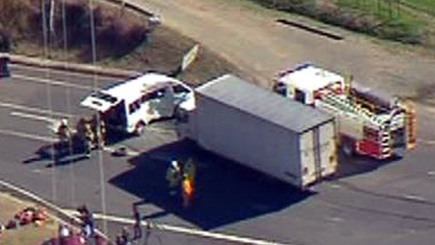 Emergency crews attend a crash between a truck and a mini-bus south of Brisbane.
