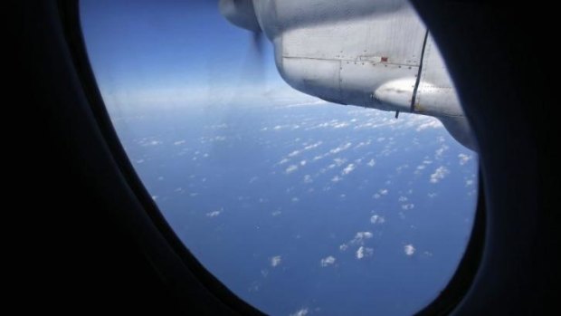 Clouds hover outside the window of a Vietnam Air Force aircraft AN-26 during a mission to find the missing Malaysia Airlines flight MH370.
