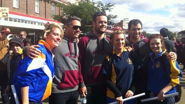 Reaching out ... Queensland players Corey Parker, Nate Myles and Cameron Smith pose with fans.