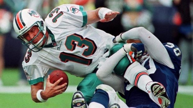 Hard knock ... Miami Dolphins quarterback Dan Marino grimaces as he is sacked by Indianapolis Colts defensive end Mark Thomas in Miami on December 5, 1999.