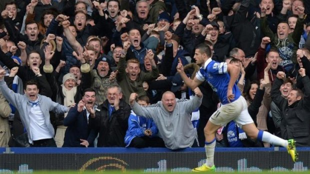 Everton fans express their delight at the game's third goal.