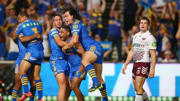 Bright future: Corey Norman, Chris Sandow and Tepai Moeroa of the Eels celebrate after Sandow's try on Friday.