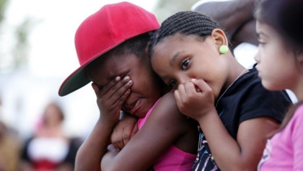 Children cry during the prayer vigil for slain Martin Cobb.