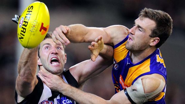 Front line smothered ... Travis Cloke battles West Coast’s Eric Mackenzie for the ball during Collingwood’s tough win last night, which relied heavily on midfielders.