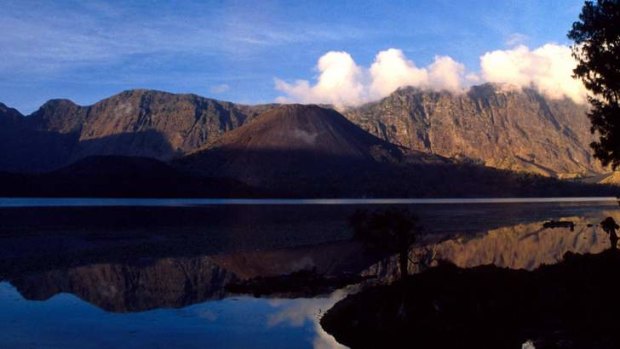 A file photo of the 3726m Gunung Rinjani, or Rinjani Mountain, an active volcano, spews clouds of gas on Lombok island, east of Jakarta, Indonesia.