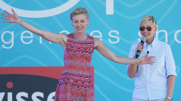 Television personality Ellen DeGeneres and her wife Portia de Rossie on stage during the filming of her television show at Birrarung Marr in Melbourne.