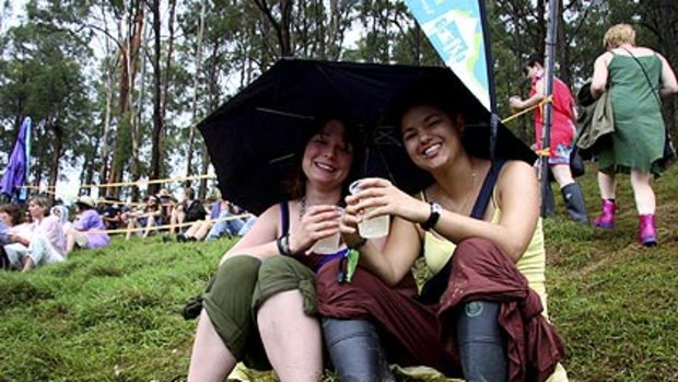 Candice Smith and Madeleine Coutanceau take cover at last year's Woodford Folk Festival.