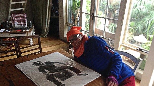 Step 6: Ross Hannaford at home with the lithograph. He says he particularly likes the feet. 