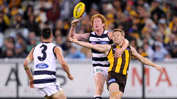 Cameron Ling spoils as Hawk Sam Mitchell tries to get possession of the ball.