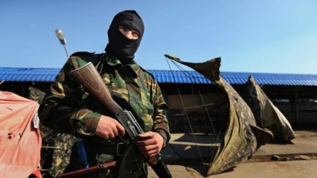 An armed pro-Russian self-defence militiaman at the border crossing with western Ukraine.