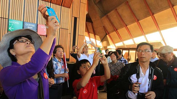 Pay-off at last &#8230; Chinese tourists, such as those seen here on a Mandarin tour of the Opera House in Sydney, are being drawn down under by a more China-friendly tourism industry.