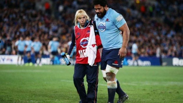 Tatafu Polota-Nau is assisted from the field during the Waratahs' Super Rugby final win.