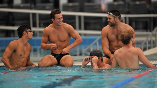 Collingwood players Sharrod Wellingham, Luke Ball and Chris Dawes take a dip during a community camp in Wangaratta.