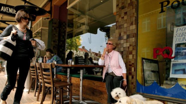 Soon to become a dog-free zone ... Barbara Standen outside The Avenue Cafe yesterday with Molly and her friend’s Labrador, Annie. ‘‘I think as long as they are well-behaved it’s fine.’’