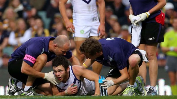 Hayden Ballantyne receives assistance from trainers during the western derby clash.