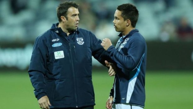 Geelong coach Chris Scott has a word with Mathew Stokes during the game.