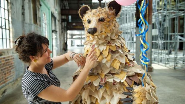 Blending elements of theatre with contemporary art: Costume designer Clare Britton adds touches to the giant bear puppet.