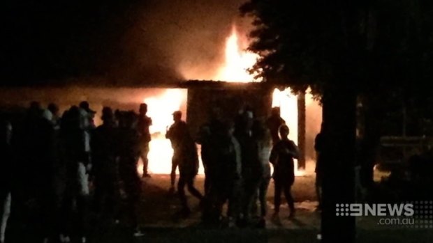 Revellers flee the Greenwood house after it is set on fire. 