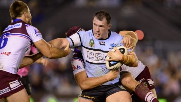 Cronulla captain Paul Gallen tries to fend off the Manly defence.