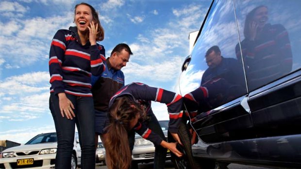 Basic skills ... New England Girls' School students Bronte Thomson-Sparrow, 17, left, and Lucille Pointing, 17, are taught how to change a tyre by Gary Wright.