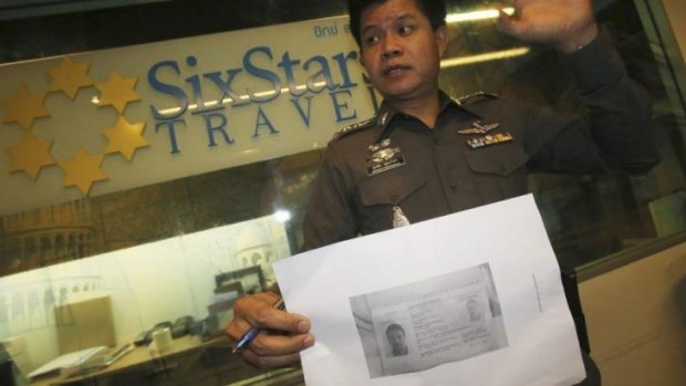 A Thai policeman shows a copy of Italian Luigi Maraldi'?s stolen passport.