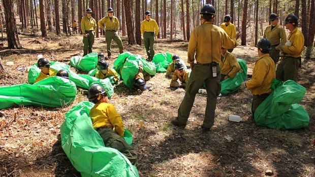 Granite Mountain Hotshots crew members set up emergency fire shelters during training in April 2012.