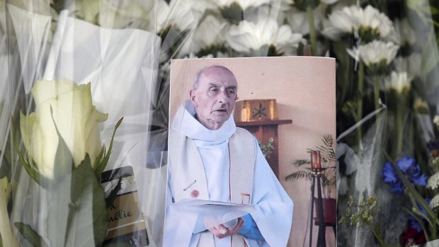 A picture of late Father Jacques Hamel at the makeshift memorial in Saint-Etienne-du-Rouvray, Normandy.